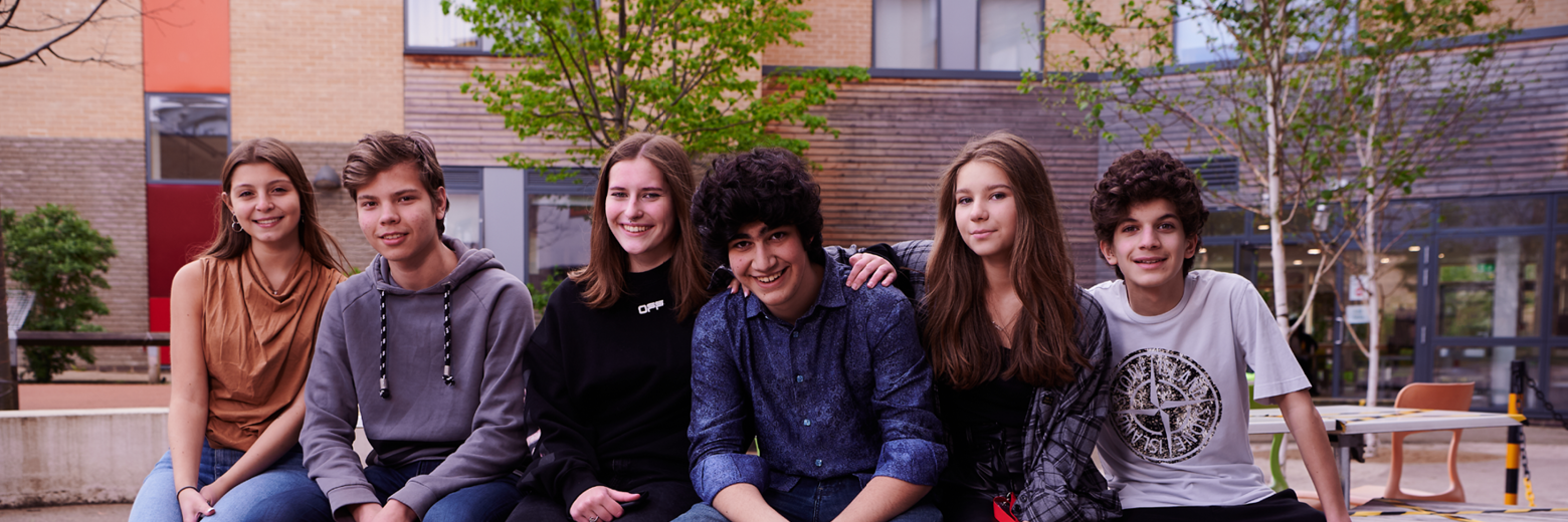 EU Students Sitting In Abbey College Cambridge Courtyard