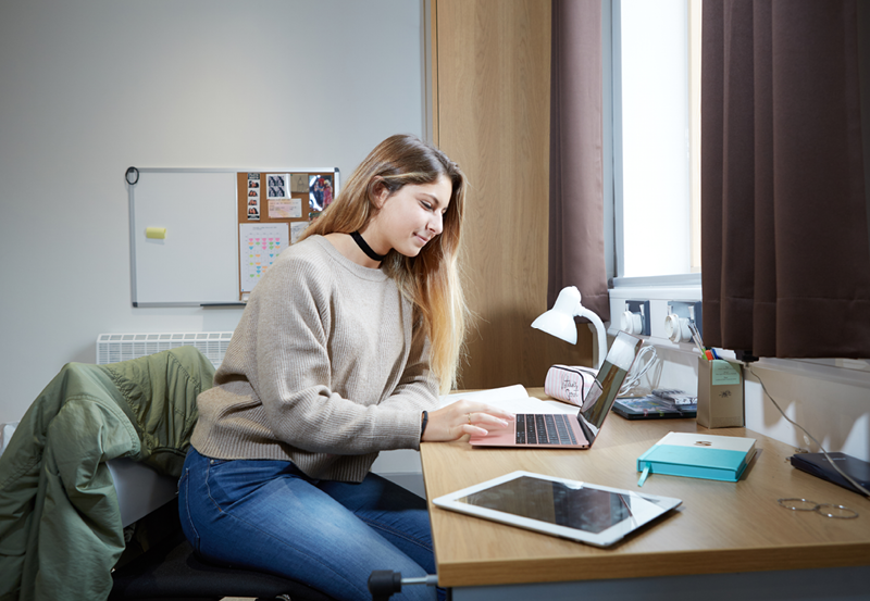 Female Student Revising In Their Bedroom At Abbey College Cambridge