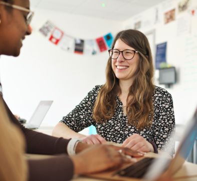 Female Teacher And Student Working In A British Classroom