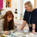 Student and teacher working in Art class