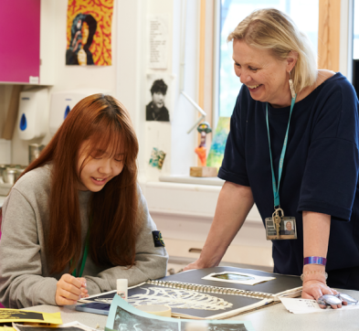 Student and teacher working in Art class